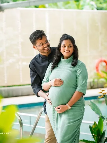 Capturing the pure joy and excitement of expecting. This candid poolside maternity photo highlights the couple's happy smiles and the beautiful baby bump.