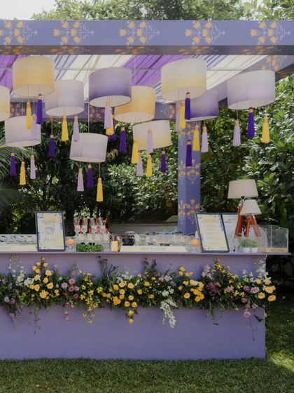 A full view of the stylish cocktail bar we designed for a pastel themed Haldi. The setup, complete with custom menus and beautiful floral arrangements, served as a central social hub for the event.