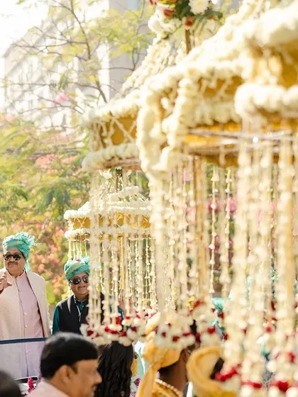 The groom's family during the baraat procession, with traditional floral umbrellas adding a touch of festive grandeur. It's these vibrant cultural elements that bring so much life to a wedding.