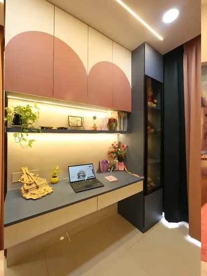 The study corner in the princess room is both functional and enchanting. It includes a sleek desk, overhead cabinets with a scalloped design, and a glass-fronted shelf for displaying favorite toys and treasures.