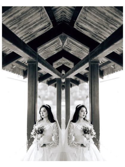 A creative black and white bridal portrait using a mirror effect. This symmetrical composition results in a unique and artistic image.