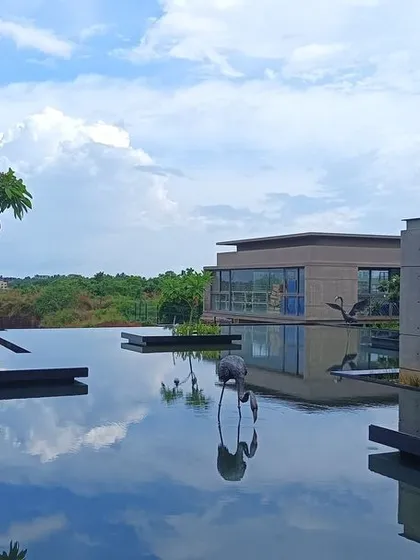 A serene water body at the Bagchi Karunashraya hospice in Bhubaneswar. The design is centered around creating a tranquil atmosphere, where the reflection of the sky on the water provides a sense of peace and dignity for residents.