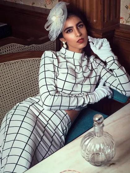 Inspired by vintage fashion, this look is pure elegance. The checked co-ord set, classic white gloves, and a delicate fascinator come together to create a timeless and sophisticated outfit reminiscent of derby fashion.