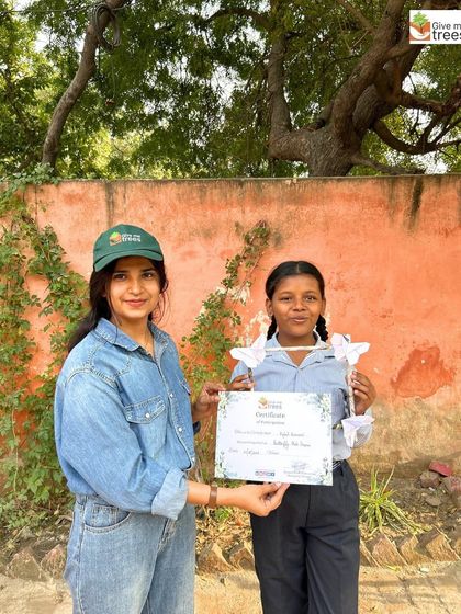 A student receives a certificate for her participation in our Butterfly Photo Frame Workshop. Recognition is important to encourage continued engagement.