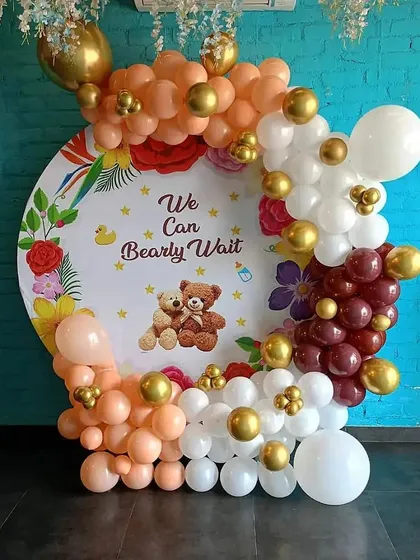 This "We Can Bearly Wait" theme is a cute and popular choice for baby showers. I created this circular backdrop with a floral and teddy bear design, surrounded by a warm-toned balloon garland.