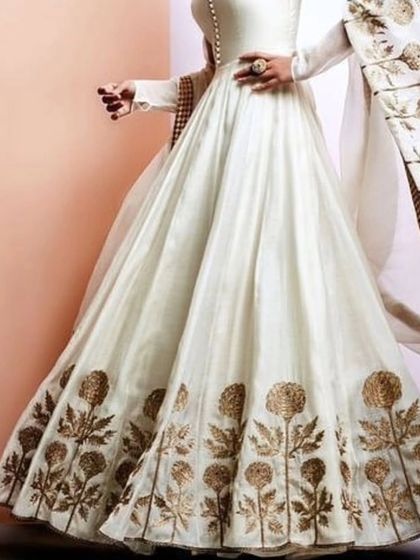 An inspiration piece showcasing a beautiful white Anarkali with gold floral embroidery. I can create similar elegant and timeless outfits based on your vision.
