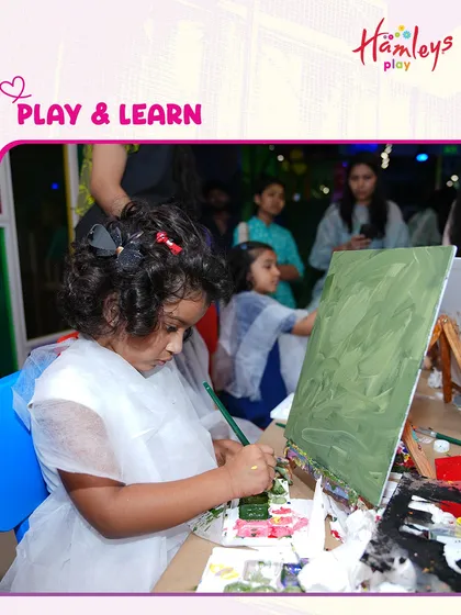 Play and learn go hand in hand. Here, a young artist is completely absorbed in her canvas painting during a playdate. I provide a space where creativity and fun can flourish together.