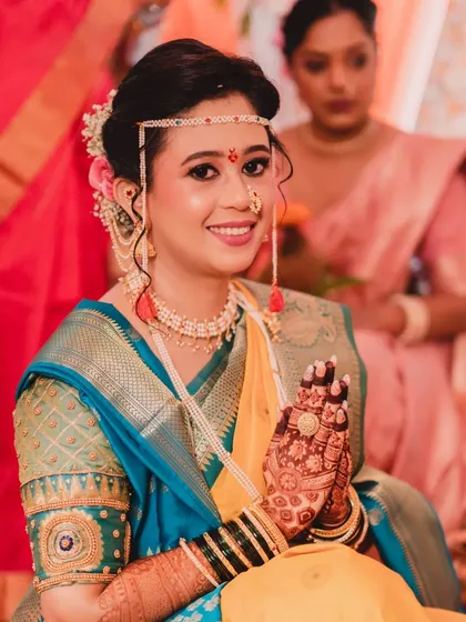A beautiful portrait of the bride, her hands joined in 'namaste'. The intricate details of her henna and the flawless makeup are on full display.
