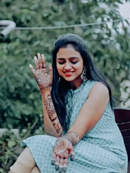 Rashmi Prabhakar waving with her beautifully adorned hand, featuring custom designs that are meaningful to her and her partner.