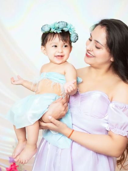 A beautiful mother and daughter moment. We provide coordinating outfits and accessories for some of our themed shoots, like this floral one.
