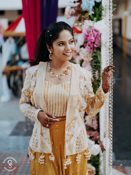 A candid portrait of the bride-to-be, looking happy and relaxed at her carnival-themed party.
