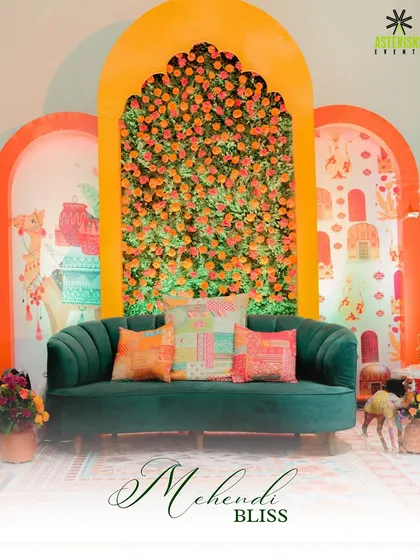 A beautiful photo-op spot with a green velvet sofa against a backdrop of orange marigolds, perfectly blending modern and traditional aesthetics.