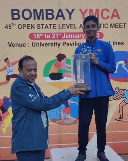 My young athlete Devaj Parekh receiving the Individual Championship trophy in the Boys U/12 category at the YMCA meet.