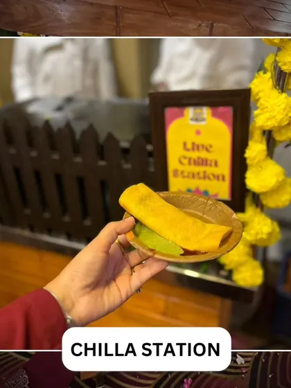 A guest holding a freshly made chilla from our live station. This personal perspective highlights the delicious end-product of our interactive cooking experience.