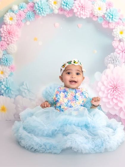 A happy, smiling portrait from the pastel rainbow and clouds setup. The soft lighting and cheerful colors make this a perfect theme for celebrating your little one.