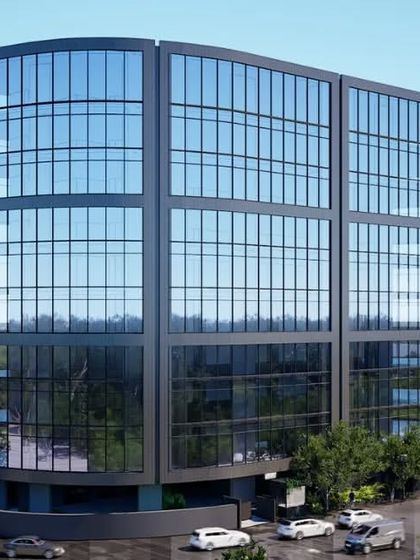 A rendering of a contemporary glass-clad office building in Mumbai. The clean, modern lines and curved facade are designed to create a distinctive corporate landmark.