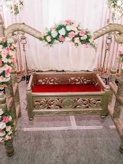 The beautifully decorated cradle, or 'thottil', waiting for the babies at the naming ceremony. This is a central part of the traditional event.