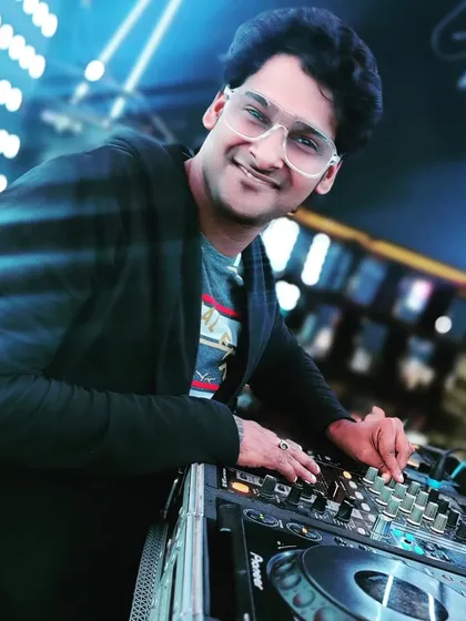 A quick smile between tracks. For me, DJing is more than just playing music; it's about connecting with the crowd and sharing the joy that every beat brings.