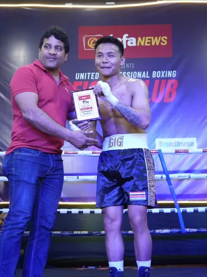 A fighter from outside our immediate team receiving his award, showing the reach and collaborative spirit of our events.