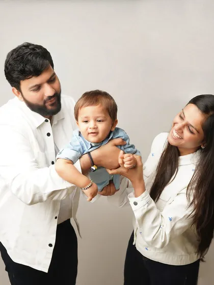 Parents playfully lift their son, all three of them sharing a laugh. I love capturing the energy and fun of a family just being themselves.