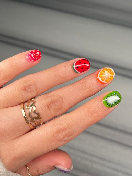 Another view of the vibrant, hand-painted fruit nails. The detail and color on each nail make this a truly joyful and eye-catching set.