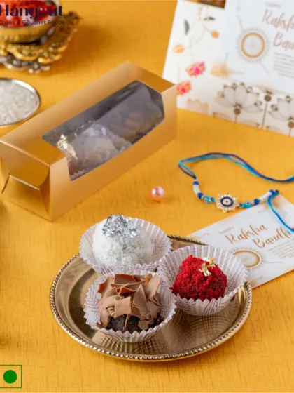I've given the traditional laddoo a modern twist with my special brownie laddoos. This box contains Milkmaid brownies blended with white chocolate, red velvet, and ganache, shaped into laddoos for a fun Rakhi treat.