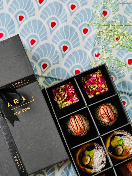 An overhead view of our beautifully arranged Malcha Box, showcasing the variety and artistry of our modern Indian sweets. Each piece is a bite-sized delight, perfect for festive celebrations.