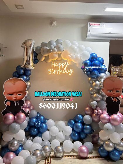 A Boss Baby themed ring decoration for a first birthday. This setup uses a cool palette of blue, silver, and white balloons with two character cutouts.