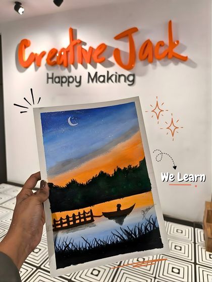 A hand holds up a finished landscape painting of a boat on a lake at dusk, set against the backdrop of my studio's "Creative Jack" logo.