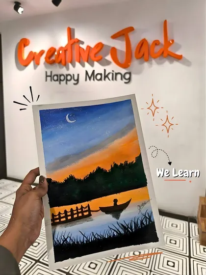 A hand holds up a finished landscape painting of a boat on a lake at dusk, set against the backdrop of my studio's "Creative Jack" logo.