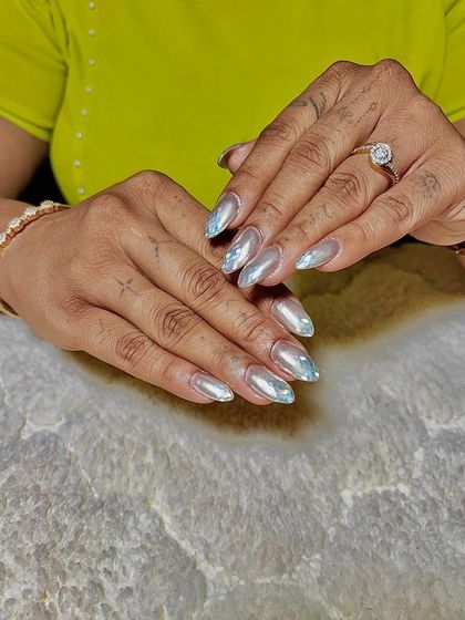 A broken-glass effect using iridescent shards over a sheer base. This creates a unique, multi-faceted shimmer.