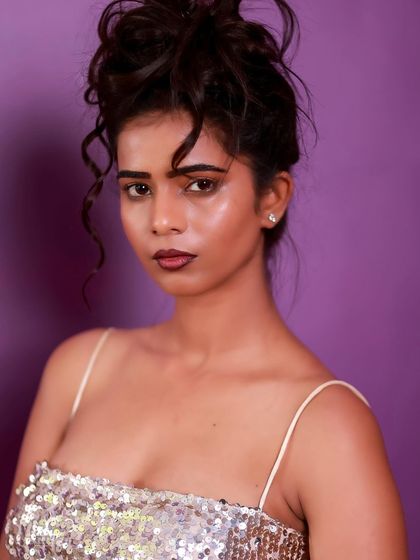 A powerful and direct close-up. Her expression is strong, and the messy updo adds a touch of rebellious glamour.