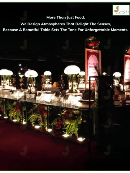 I design atmospheres, not just menus. This beautifully lit buffet setup with unique jellyfish-style lamps and lush greenery creates a magical and unforgettable dining ambiance for a nighttime celebration.