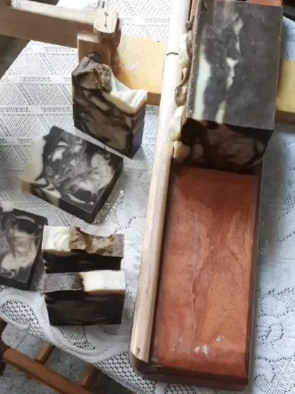 Here you can see the large block of Neem Cucumber soap being cut. The dramatic swirls are created by pouring different colored soap batters at the same time, ensuring no two bars are ever identical.