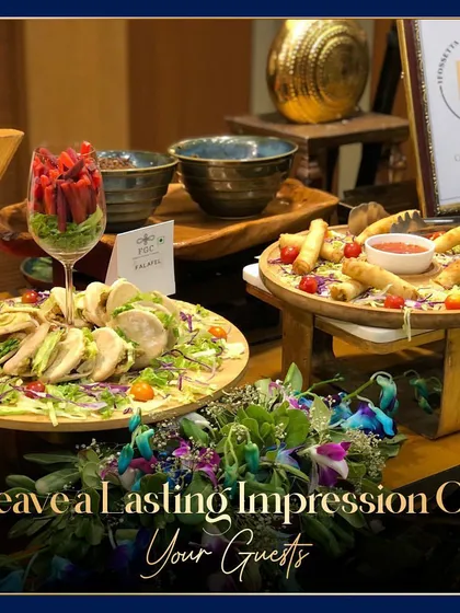 We aim to leave a lasting impression with our food presentation. Here, a Caesar salad and spring rolls are beautifully arranged on wooden platters, surrounded by fresh flowers.