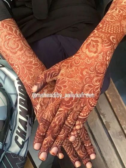 A fully developed, rich red stain covering both hands and arms.
