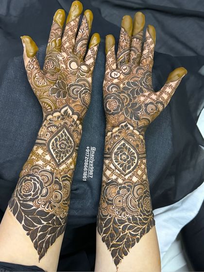 The back of the hands for the same design, continuing the theme of paisley and floral work up to the elbow.