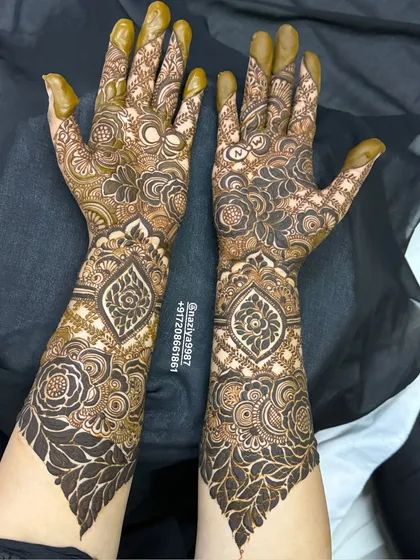 The back of the hands for the same design, continuing the theme of paisley and floral work up to the elbow.