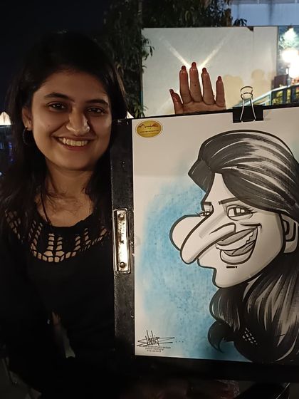 Her smile and the nice blue background in the caricature make for a great photo.