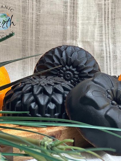 My "Wake Me Up" soap, crafted with activated charcoal and a hint of orange. These intricately molded bars are designed to detoxify and refresh your skin.