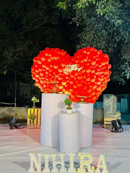 The same red heart decoration in a daytime outdoor setting, showing its impressive scale and vibrant color.