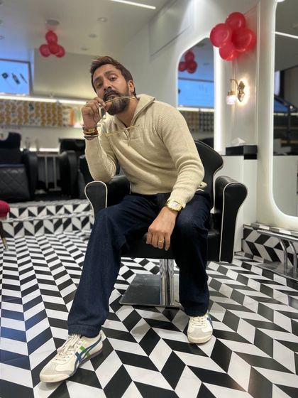 Taking a moment in my workspace. The salon's modern design reflects my approach to hairstyling: clean, sharp, and stylish.