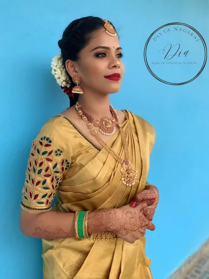 Another angle from this traditional photoshoot. The combination of the golden saree, red lip, and classic jewellery is a timeless choice for any bride or festive occasion.