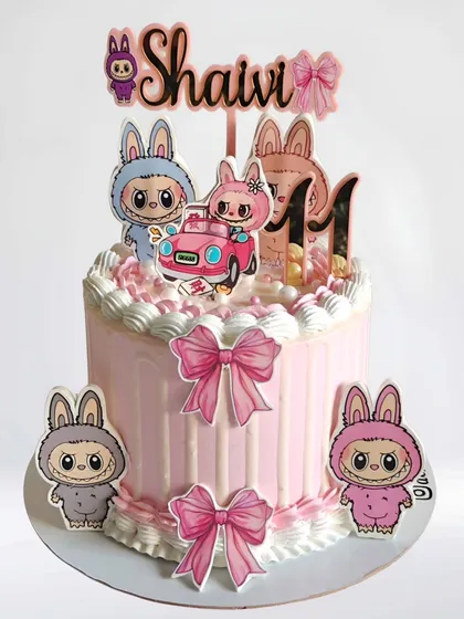 A cute and trendy Labubu-themed cake for an 11th birthday. This pink whipped cream cake features the popular art toy characters.