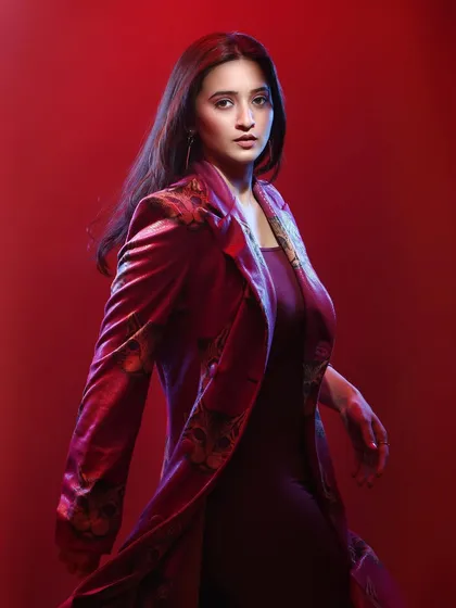 This shot from a fashion series shows how I create a complete look with styling and atmosphere. The movement in the pose, combined with the soft, red-toned lighting, gives the image an editorial quality that highlights the outfit and the model's presence.