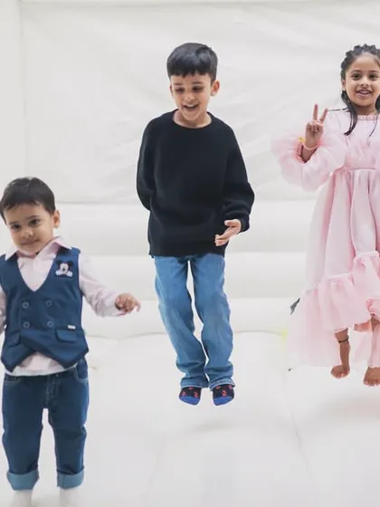 Kids jumping for joy inside our spacious white bouncy castle. The high walls and soft floor ensure a safe environment for energetic play.