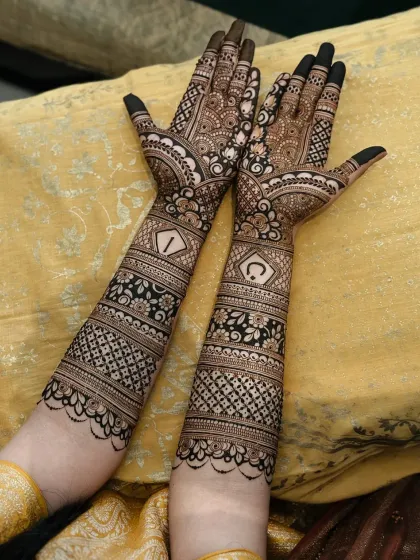 Here, the couple's initials are placed inside geometric frames, making them a central part of the design. It's a modern way to add a personal touch to traditional bridal mehndi.