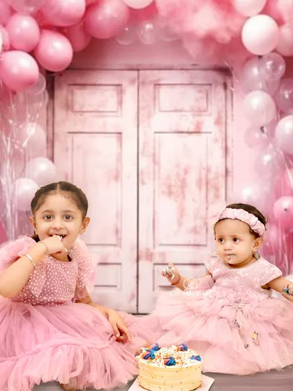 Sibling cake smashes are beautifully chaotic. Capturing these two sisters sharing a sweet and messy moment together creates a memory the whole family will cherish.