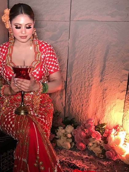 The warm, candlelit glow enhances the rich colors of this contemporary outfit and the soft, radiant makeup.