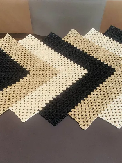 A close-up shot of the chevron table runner, highlighting the texture of the crochet stitches.